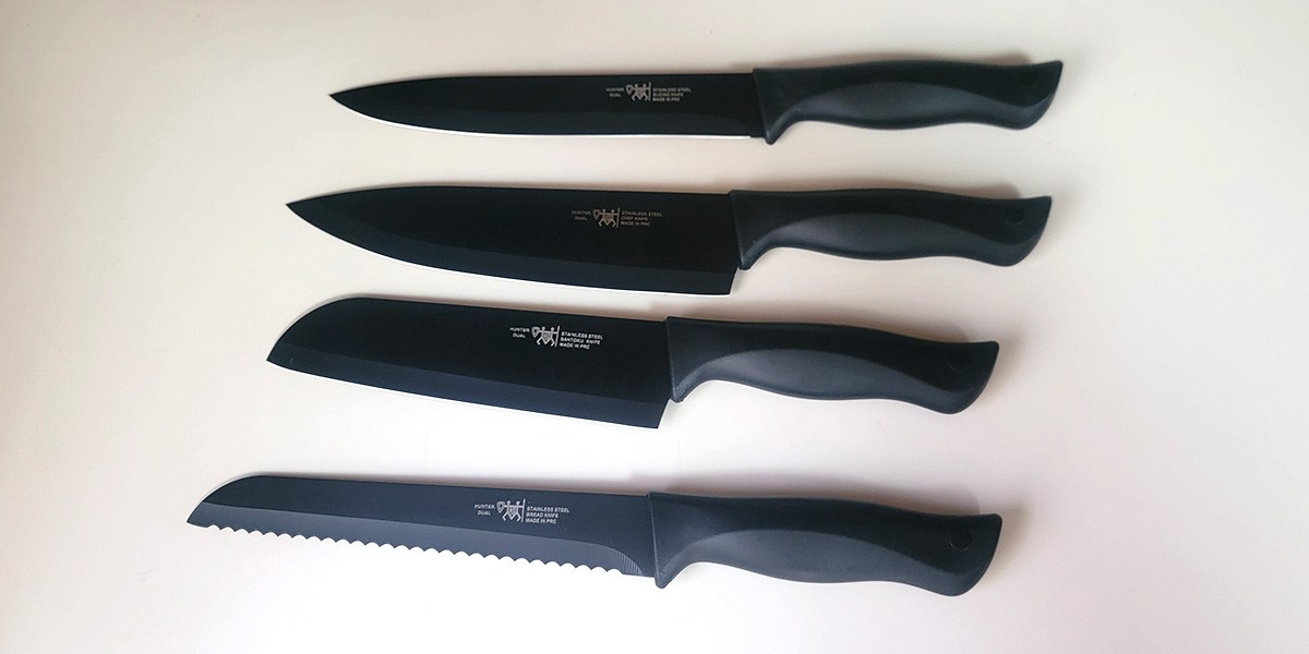 Four black Hunter.Dual Knife Set knives displayed on counter Four black Hunter.Dual Knife Set knives displayed on counter