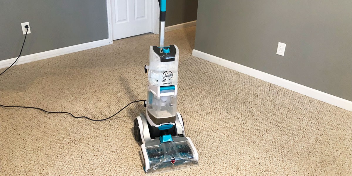 Front view of Hoover SmartWash+ Automatic Carpet Cleaner on beige carpeting Front view of Hoover SmartWash+ Automatic Carpet Cleaner on beige carpeting